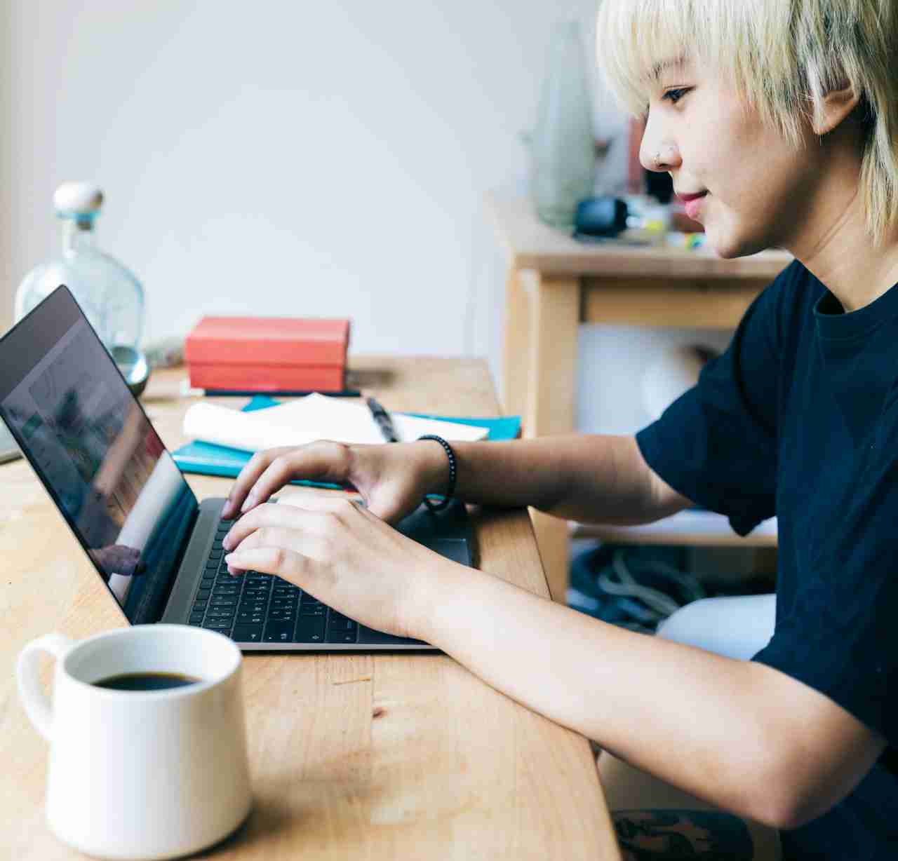 woman looking at a laptop with a smile